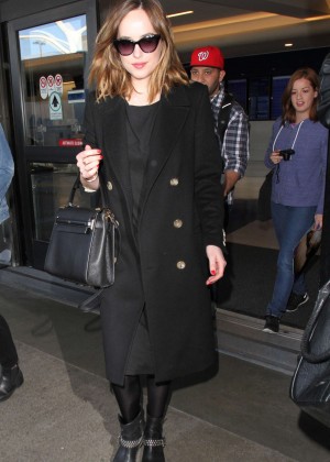 Dakota Johnson in Black Coat at LAX Airport in LA