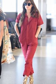 Dakota Johnson in Red Jumpsuit - Arrives at Los Angeles International Airport