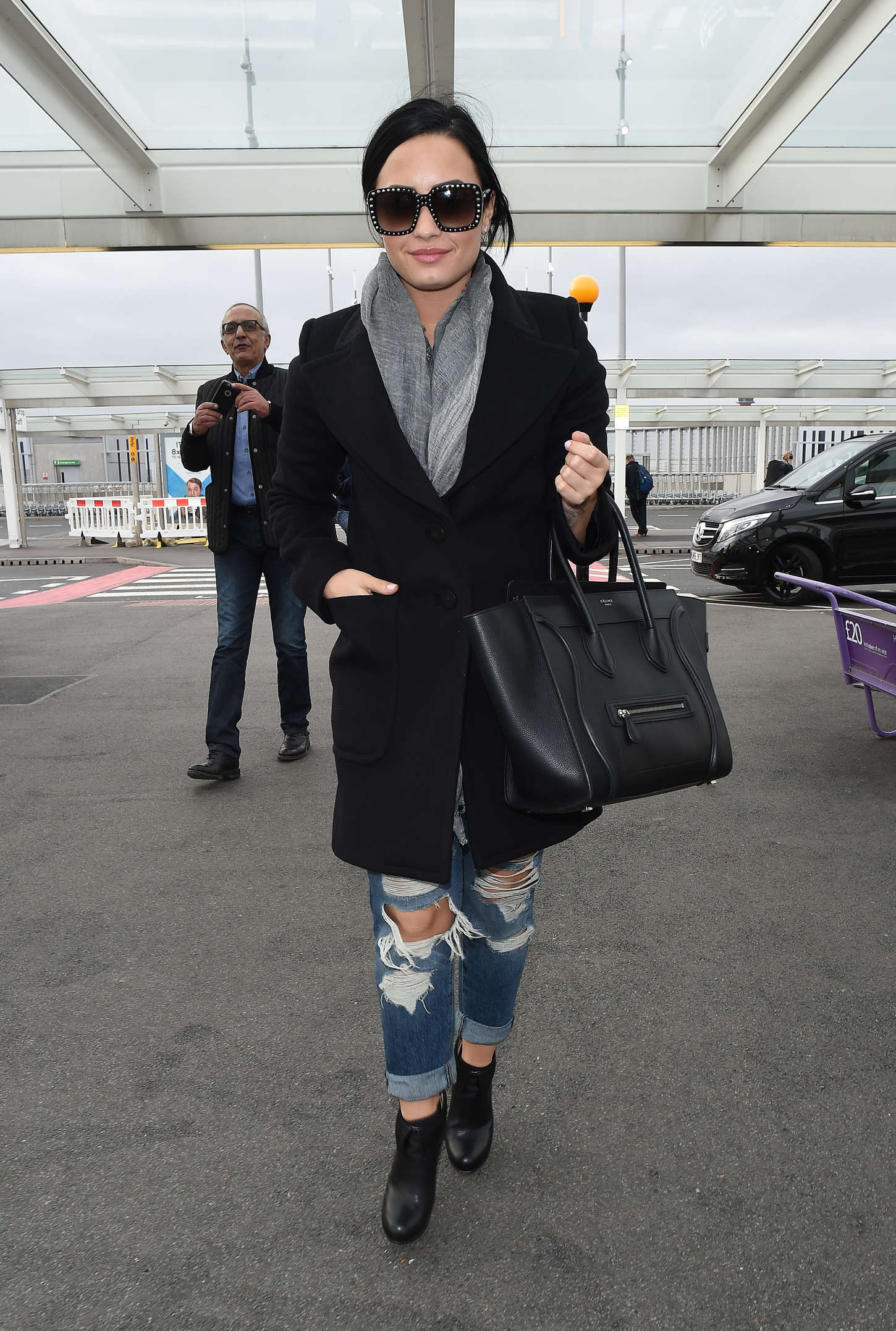 Demi Lovato in Ripped Jeans at Heathrow Airport in London