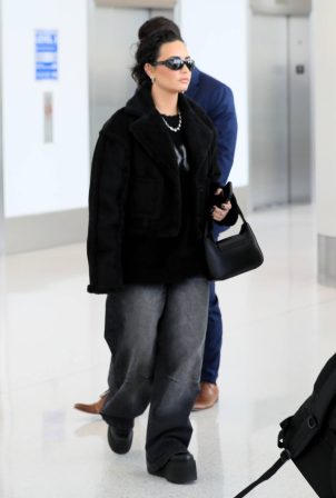 Demi Lovato - With boyfriend Jutes catch a flight out of Los Angeles
