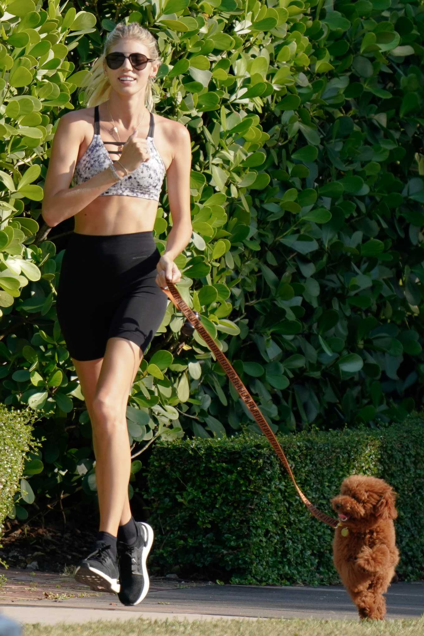 Devon Windsor â€“ Jogging while walking her dog in Miami
