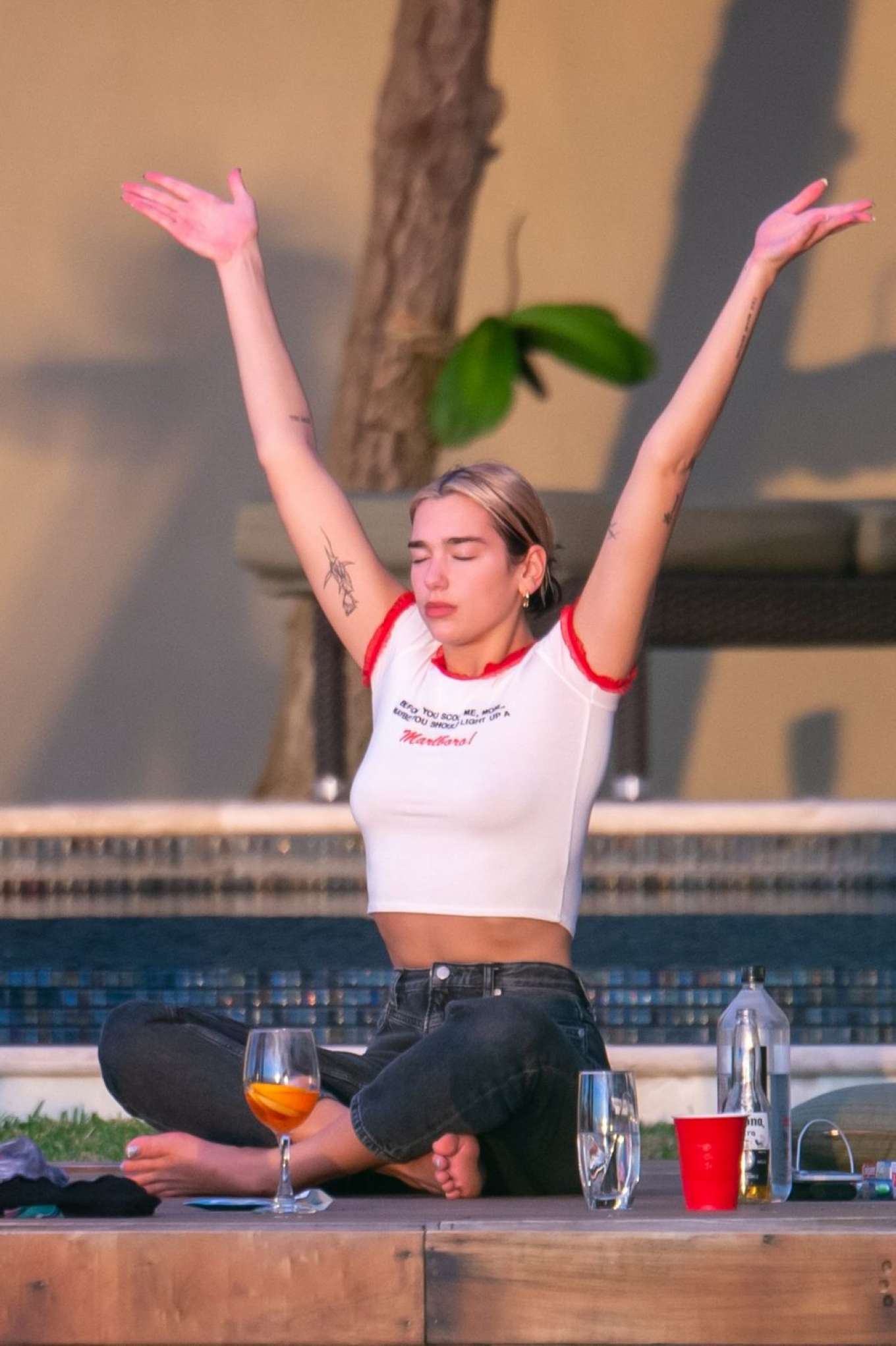 Dua Lipa doing yoga on the pool in Miami