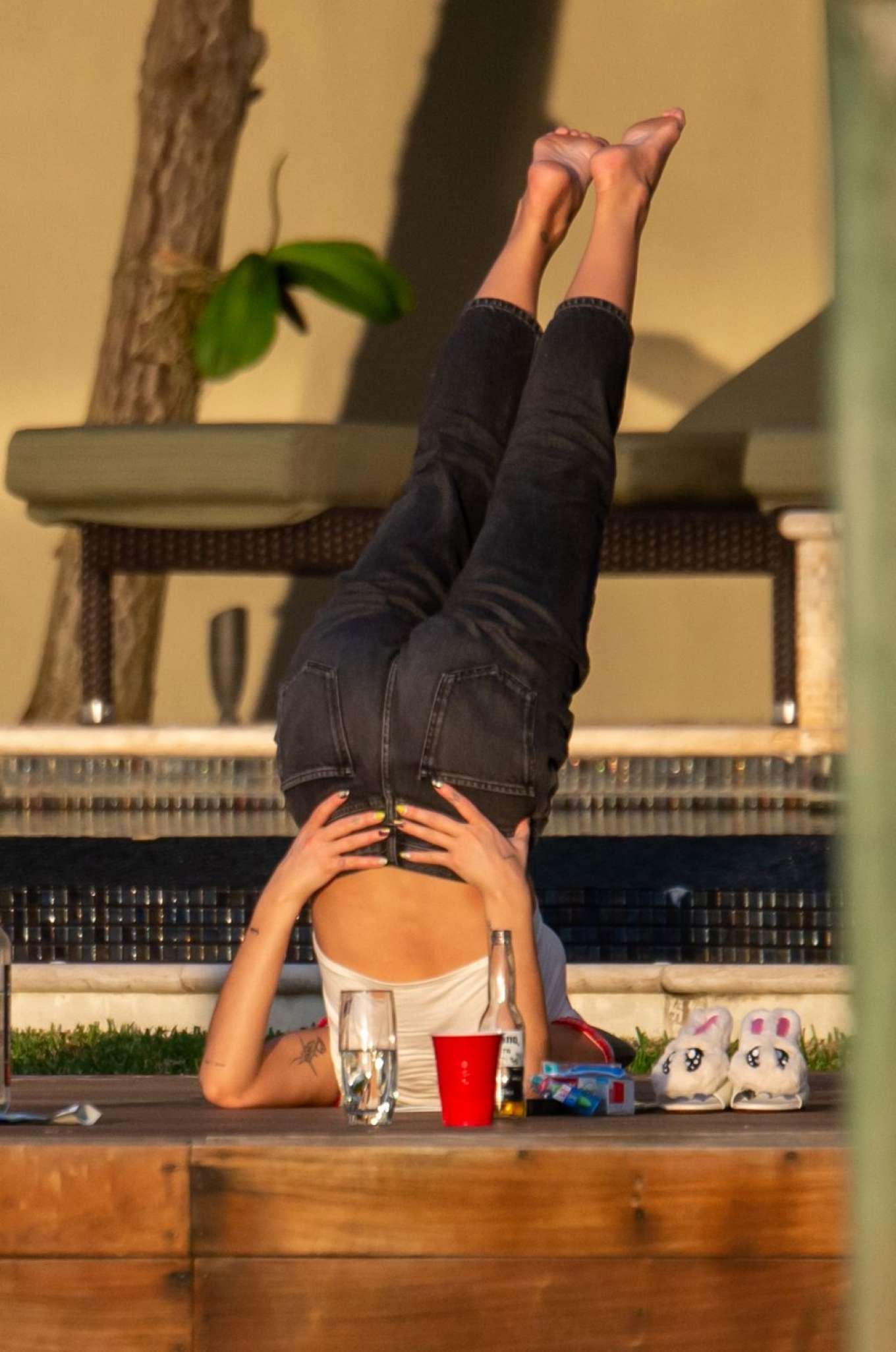 Dua Lipa doing yoga on the pool in Miami. 