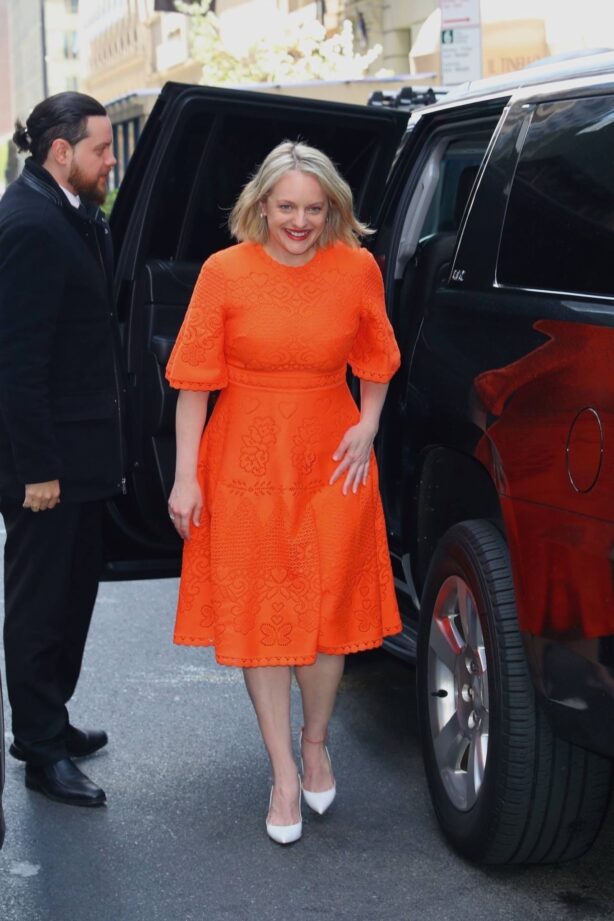Elisabeth Moss - In a bright orange dress out in New York