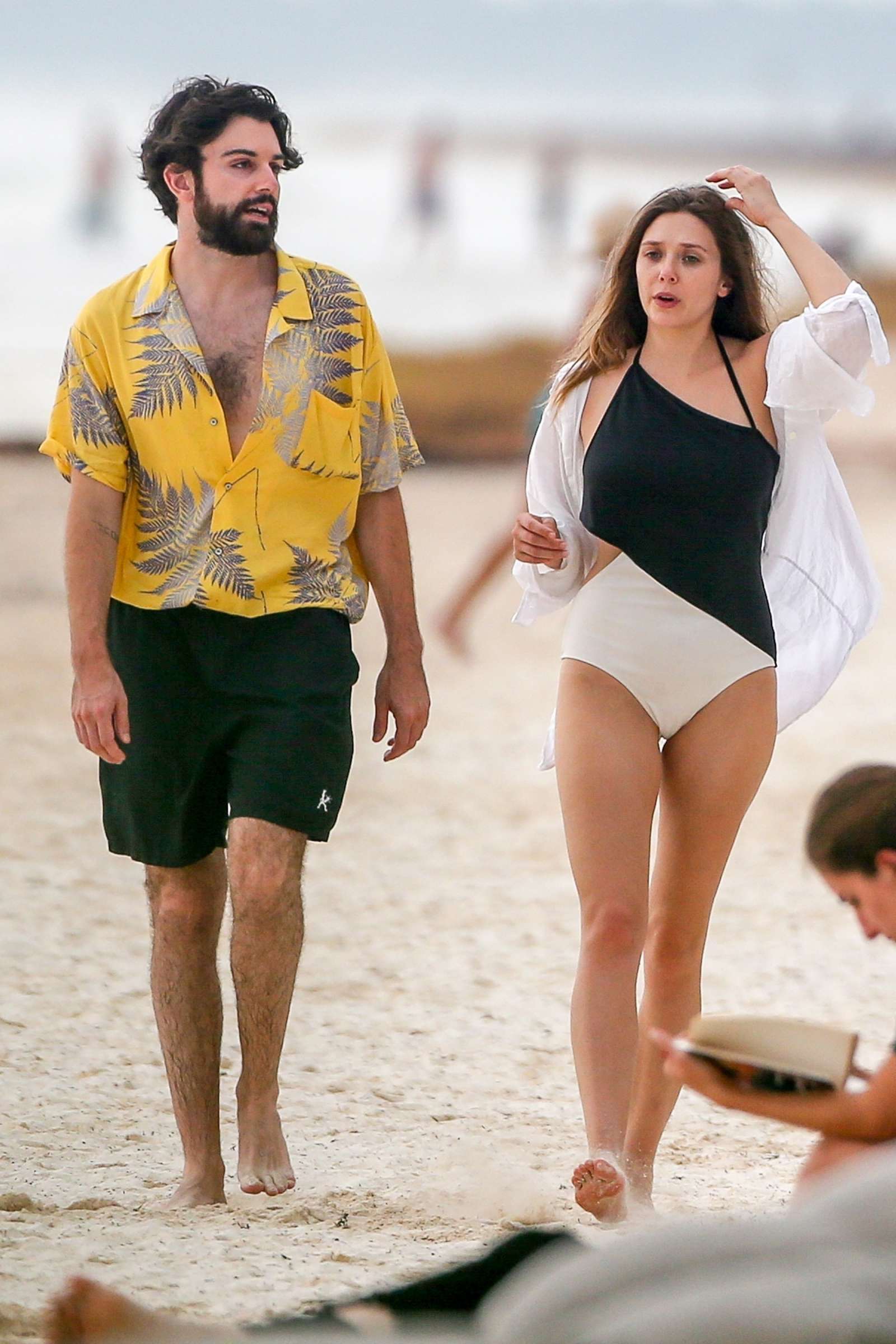 Elizabeth Olsen in Black and White Swimsuit at a beach in Mexico. 