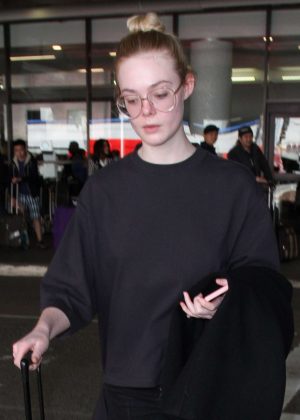 Elle Fanning in Black Arrives at LAX airport in Los Angeles