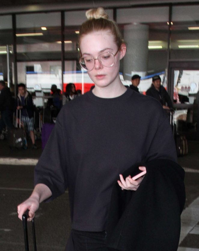 Elle Fanning in Black Arrives at LAX airport in Los Angeles