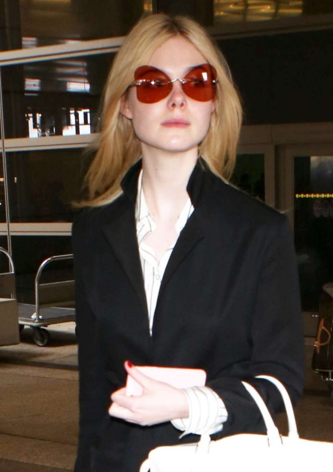 Elle Fanning in Black Coat at LAX airport in Los Angeles