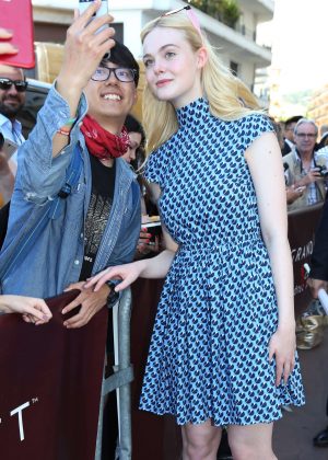 Elle Fanning poses for fans at Martinez Hotel in Cannes