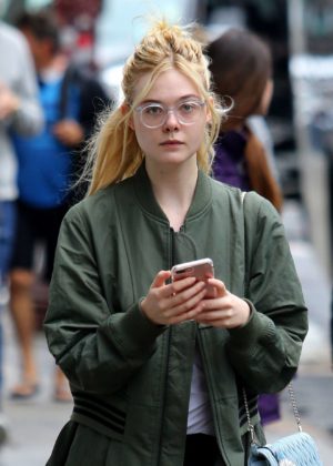 Elle Fanning - Sports stylish glasses in Manhattan