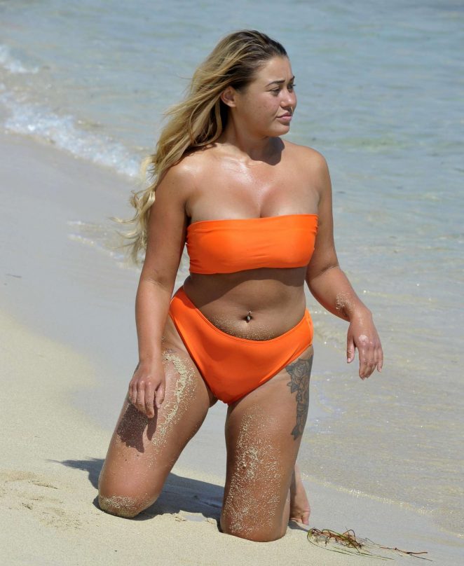 Ellie Young in Orange Bikini on the beach in Magaluf