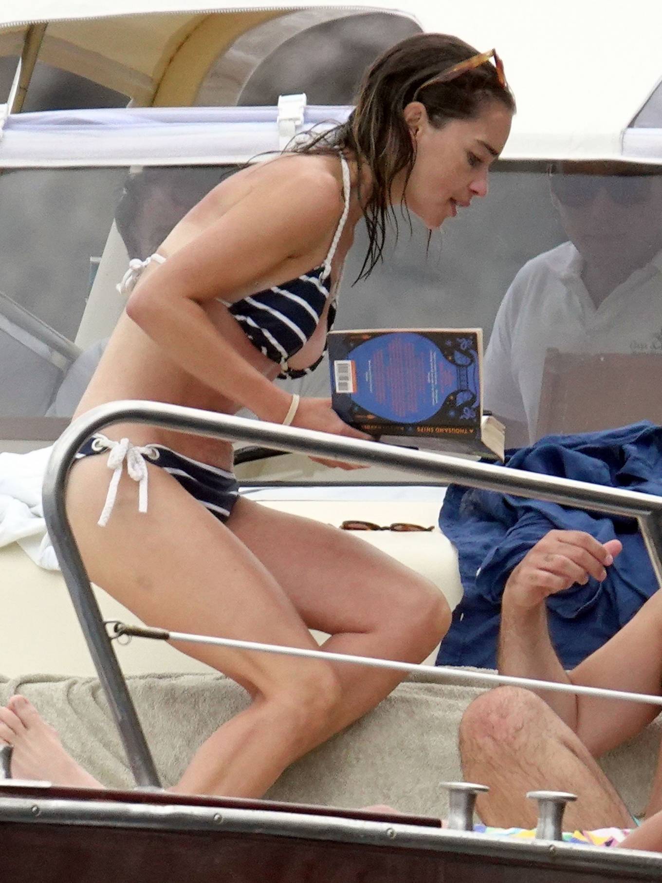 Emilia Clarke - Wearing bikini on vacation in Italy. 