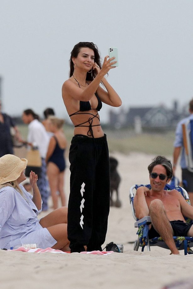Emily Ratajkowski - In a bikini relaxes on the beach in The Hamptons