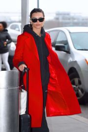 Emily Ratajkowski in red coat ready for flight at JFK airport