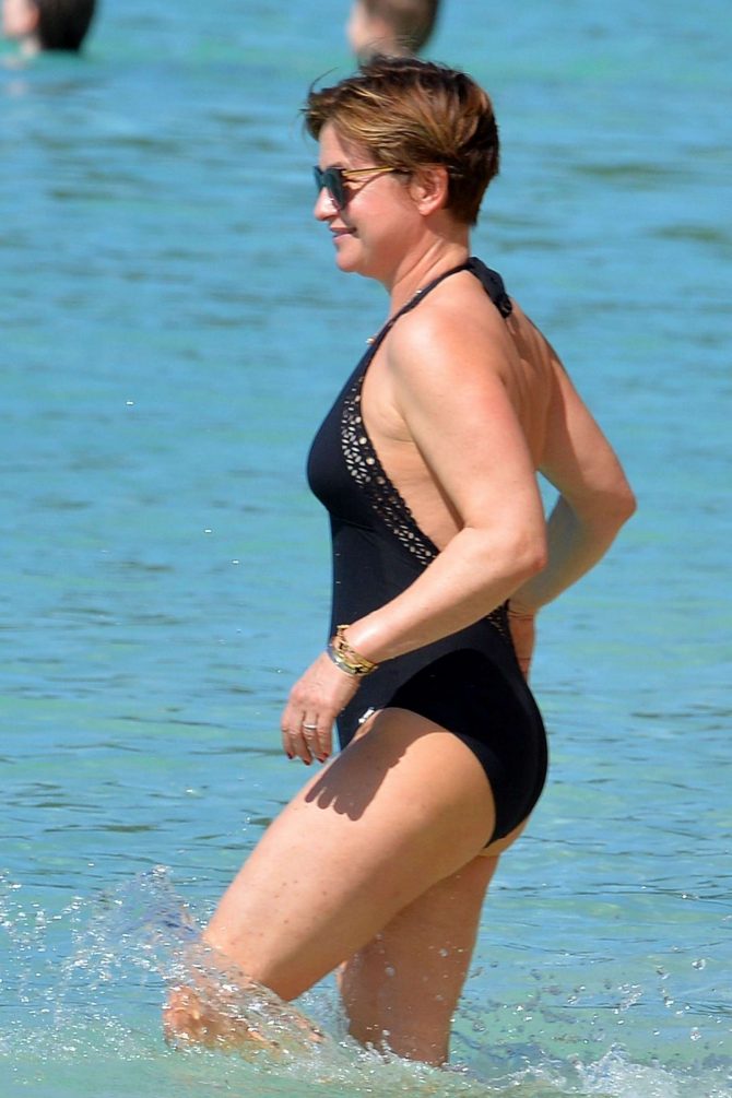 Emma Forbes in Black Swimsuit on the beach in Barbados
