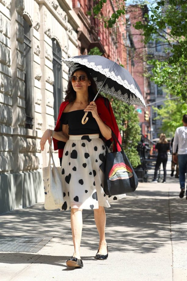 Famke Janssen - Hides from the sun with an umbrella in the West Village