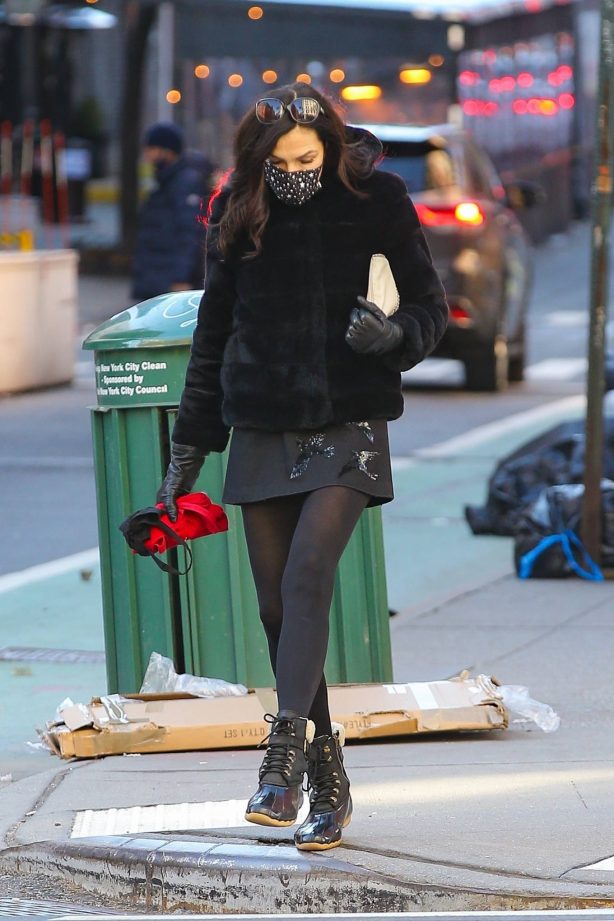 Famke Janssen - Wearing a Black Faux Fur Puffer Jacket with a mini-skirt in Manhattan