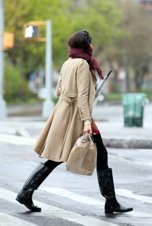 Famke Janssen - Wears her scarf as a mask while returning home in New York