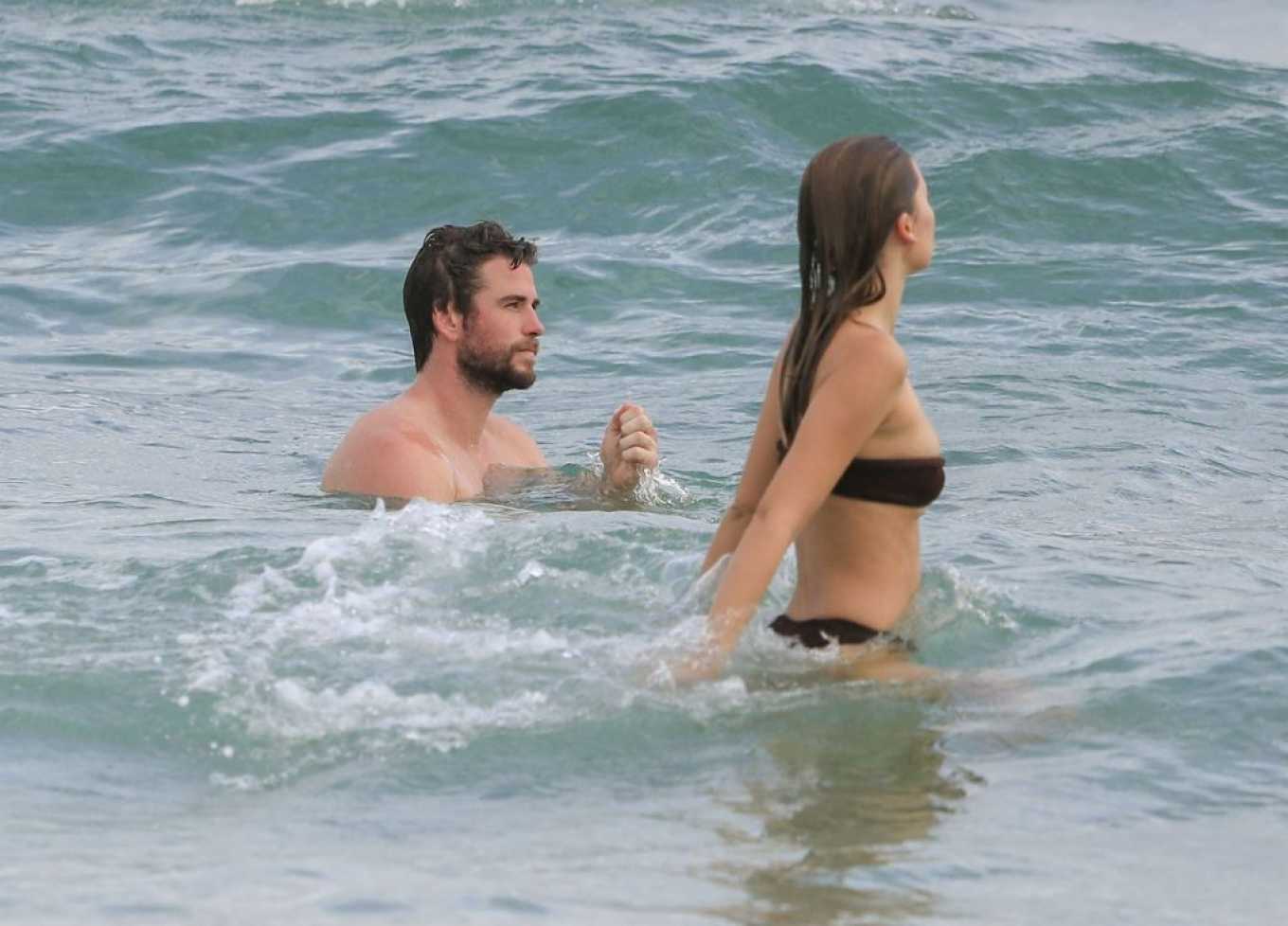 Gabriella Brooks in Black Bikini and Liam Hemsworth on the beach in Byron Bay