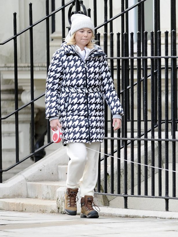 Georgia Toffolo - Wearing woolly hat and dog-tooth pattern puffa jacket in London