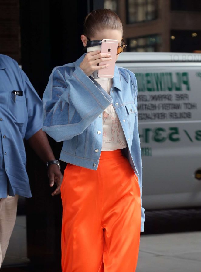 Gigi Hadid in orange trousers out in NYC