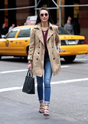 Gina Simone in a trench coat and jeans out in New York City