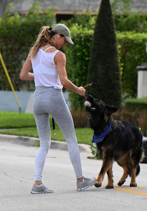 Gisele Bundchen - Seen while walking and playing with her German Shepherd in Surfside