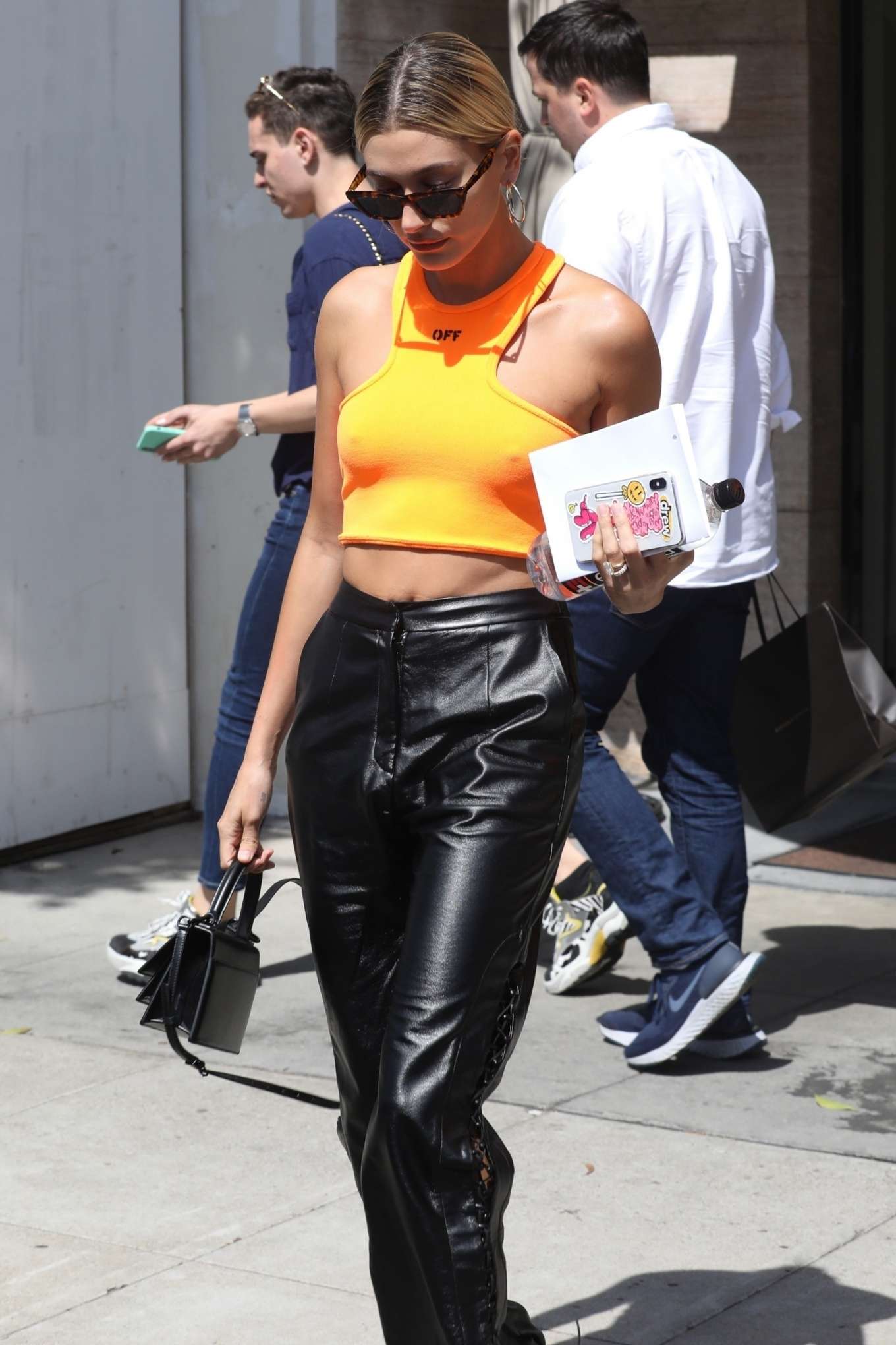 Hailey Baldwin â€“ Wearing an orange tank top and leather pants out in Los Angeles