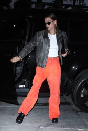 Hailey Bieber - In orange pants and leather jacket arrives at church in Los Angeles