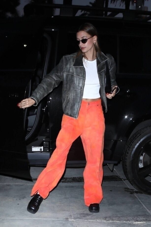 Hailey Bieber - In orange pants and leather jacket arrives at church in Los Angeles