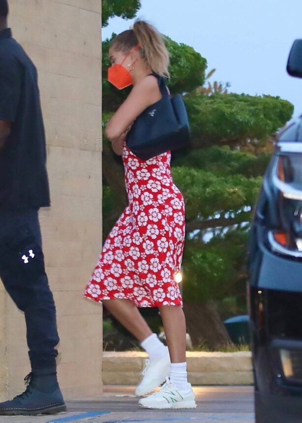 Hailey Bieber - Seen with friends in a red floral print dress at Nobu in Malibu