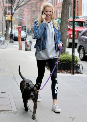 Hailey Clauson in tights walks her dog in New York City