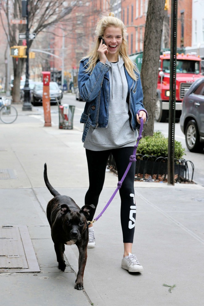 Hailey Clauson in tights walks her dog in New York City