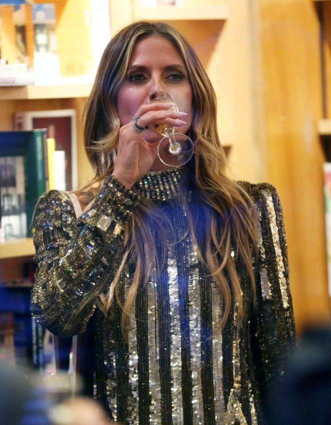 Heidi Klum in a gold dress at a party in New York City