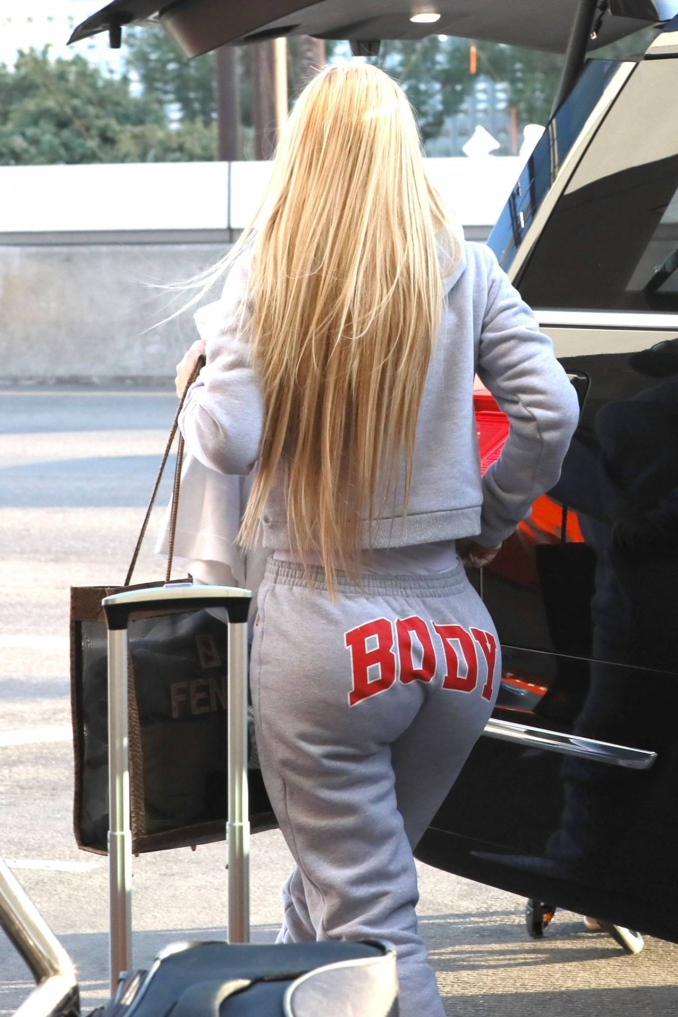 Iggy Azalea - In grey sweatpants catches a flight with her baby out of LAX