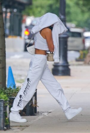 Irina Shayk - hides her face while arriving back home after photos with Kanye West in France