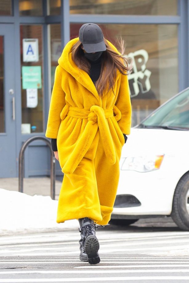 Irina Shayk - Seen in a yellow long puffy coat on a stroll in New York