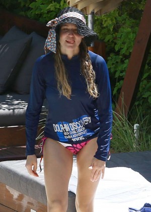 Jewel Kilcher in bikini bottoms at a pool in Miami