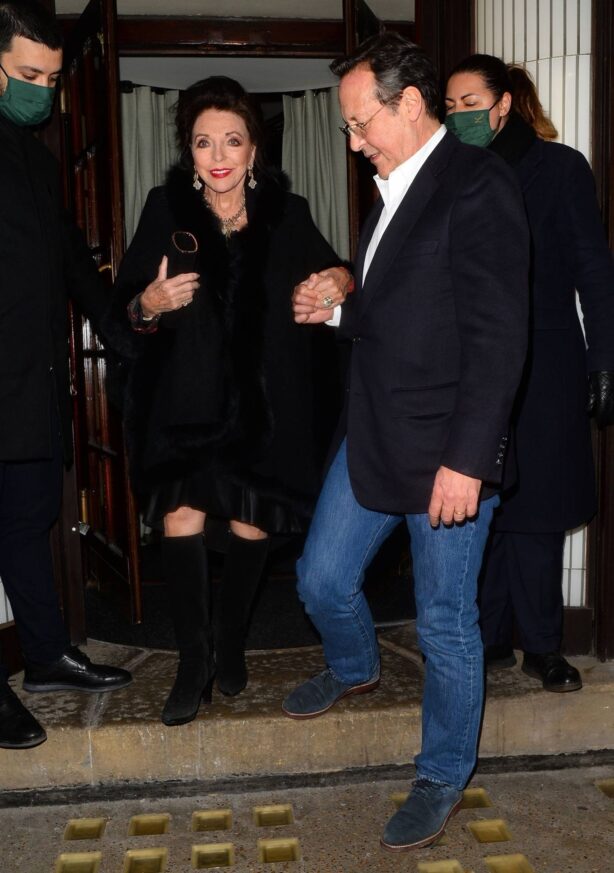 Joan Collins - In a black fur poncho with husband Percy Gibson leaving Langan's Brasserie in London