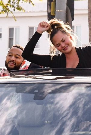 John Legend and Chrissy Teigen celebrate the Joe Biden’s win while riding around in West Hollywood