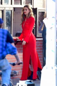 Josephine Skriver in red outfit filming set for Maybelline shoot in NYC