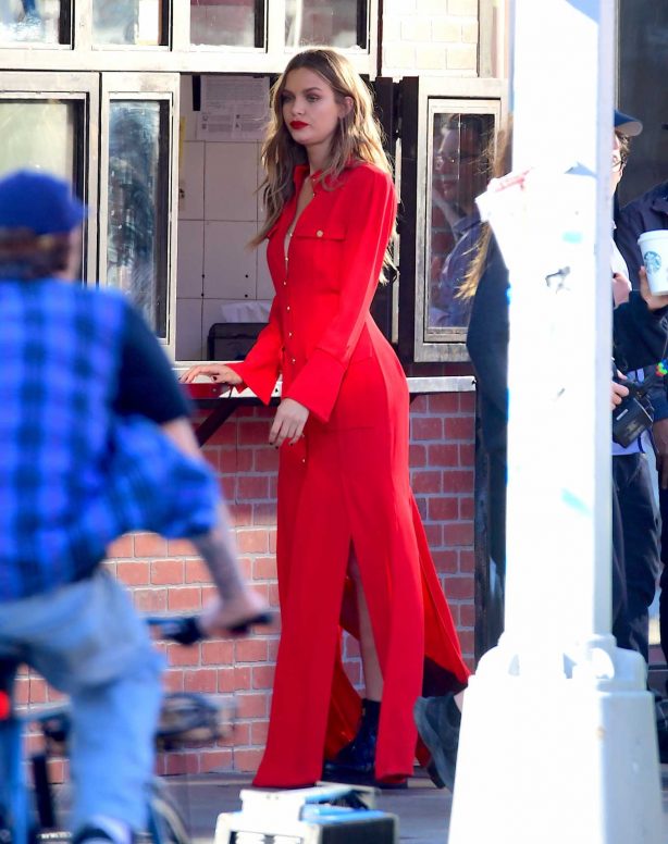Josephine Skriver in red outfit filming set for Maybelline shoot in NYC