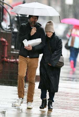 Julianne Moore - Seen Under an umbrella during a very rainy day in New York
