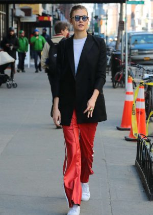 Karlie Kloss in red sport pants out in New York City