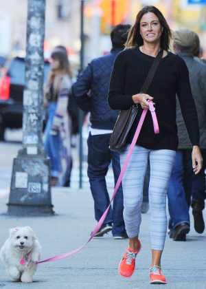 Kelly Bensimon in Tights  with her dog in Soho
