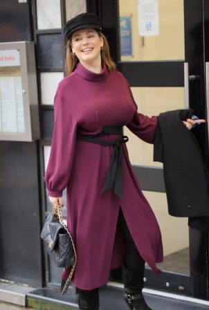 Kelly Brook - in a stylish plumb dress and hat in London