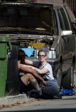 Kelly Osbourne - With her boyfriend Erik Bragg helping him fix his old station wagon in Los Angeles
