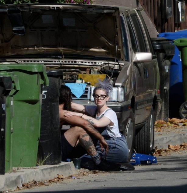 Kelly Osbourne - With her boyfriend Erik Bragg helping him fix his old station wagon in Los Angeles