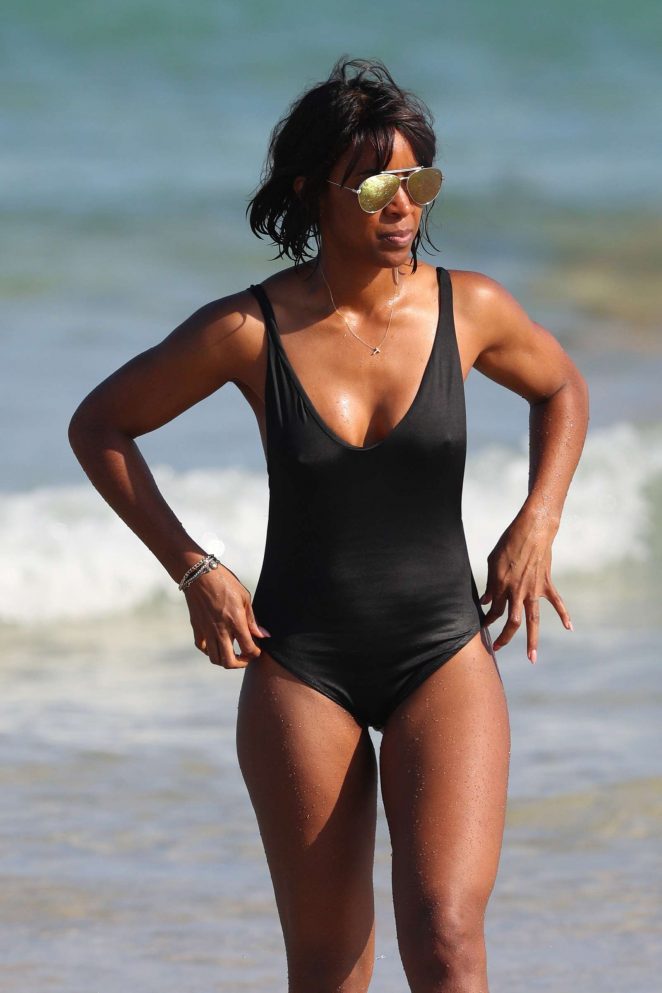 Kelly Rowland in Black Swimsuit on the beach in Sydney