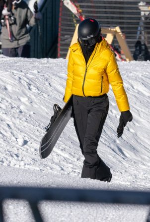 Kendall Jenner - In a ticket-me-yellow Prada jacket and black Prada trousers in Aspen